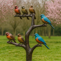 Bronzen vogels op tak